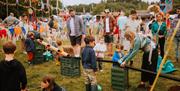 Devauden Music Festival 2025 sunny field in monmouth with children playing and flags flying festival