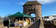 Monnow Bridge Markets - Local Produce stalls / green tents on Monow Bridge over river