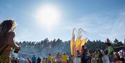 Scene shows a samba band dancing under a beautiful blue sky (without a cloud in it!)