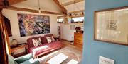 Box Barn Raglan accommodation showing sitting room country style decoration and wooden beams in monmouthshire rural location
