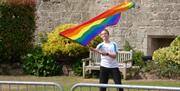 boy waves rainbow flag at cladicot castle