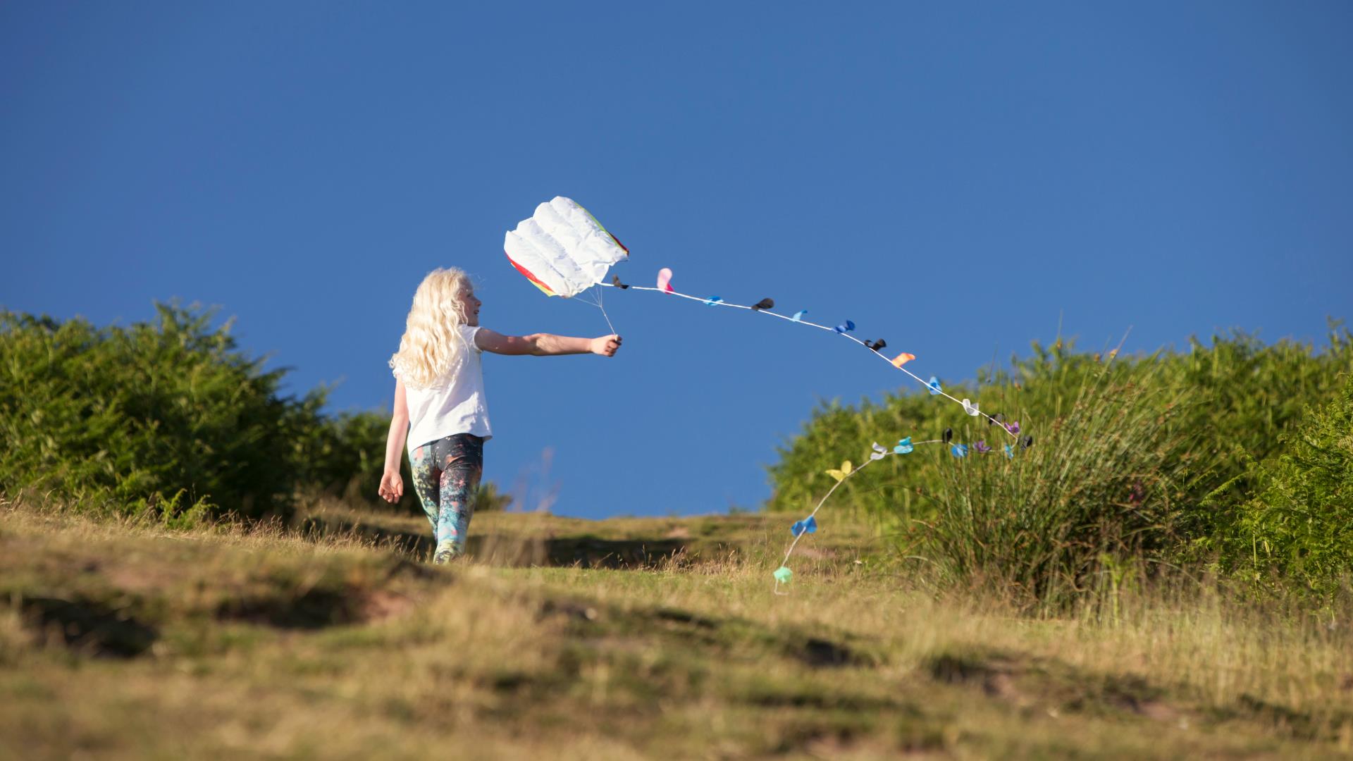 girl enjoys summer and flying kite in monmouthshire