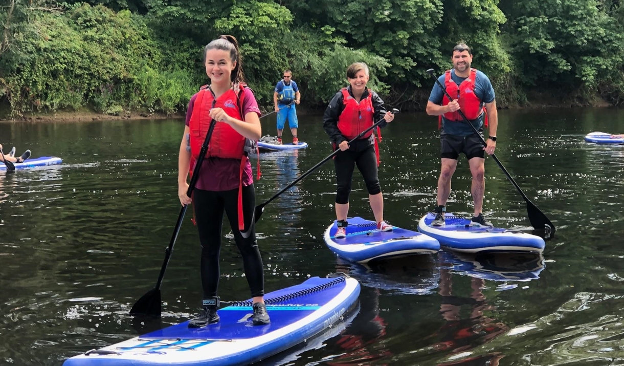 Stand-up paddleboarding on the River Wye in the Wye Valley Monmouthshire Wales for all, families, friends & team building days out.