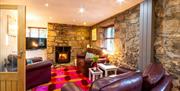 Has comfortable leather seating, an oak floor and rug, a  large screen TV and an irriststible woodburner!