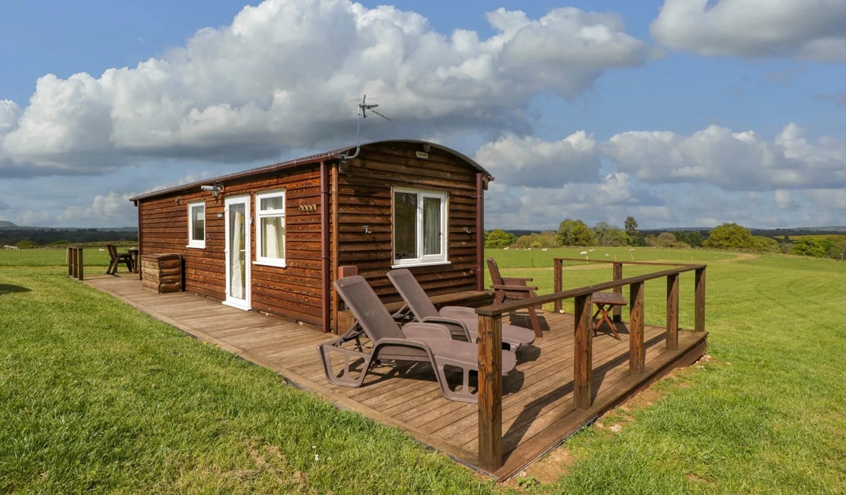 Harvest Home Shepherd Lodges made of wood looks like shepherds hut in field blue skys in monmouthshire near cardiff Harvest Home Shepherd Lodges made of wood looks like shepherds hut in field blue skys in monmouthshire near cardiff