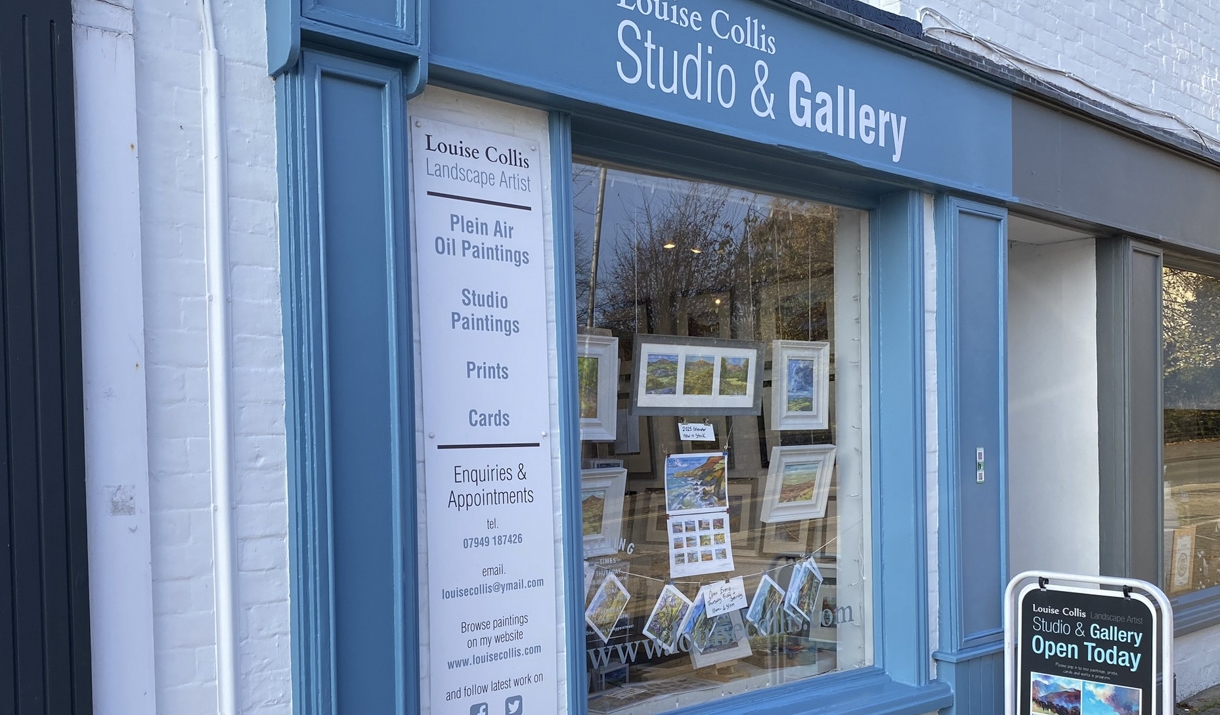 Louise Collis Studio & Gallery shop in Abergavenny blue painted wooden window frame with artwork in window Louise Collis Studio & Gallery shop in Abergavenny blue painted wooden window frame with artwork in window