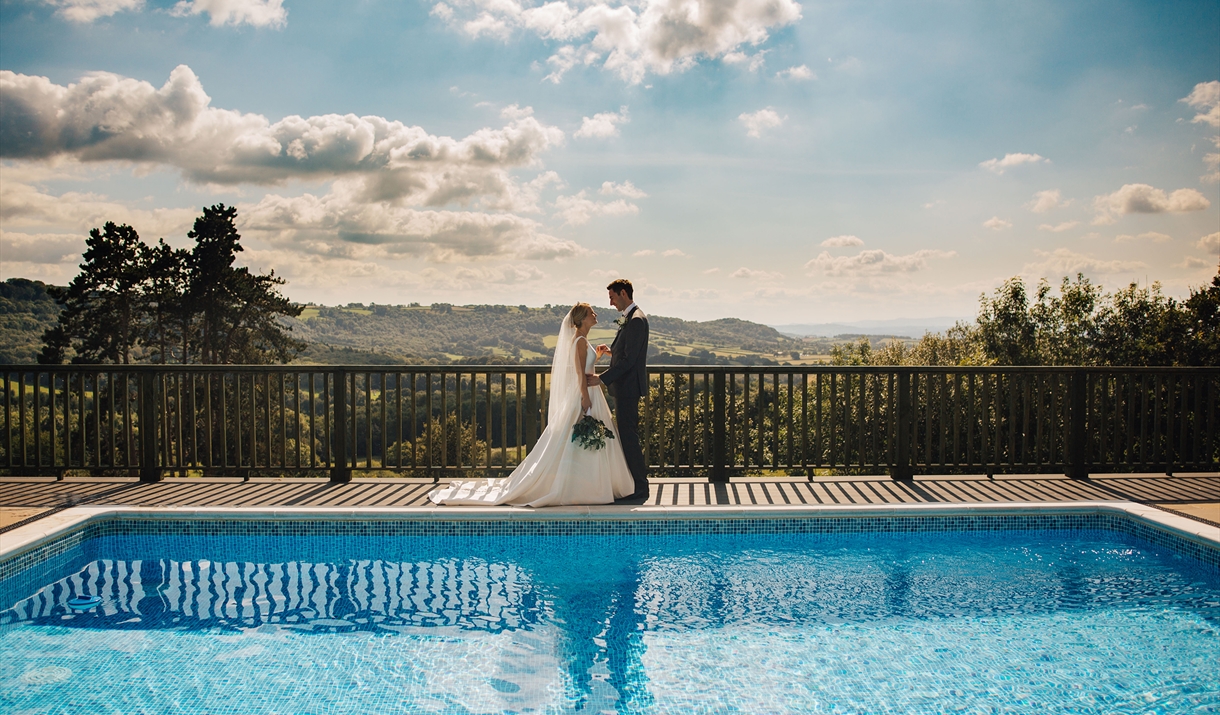 Loveseen photography captured wedding couple by swimming pool at Caer Llan in Monmouthshire Loveseen photography captured wedding couple by swimming pool at Caer Llan in Monmouthshire