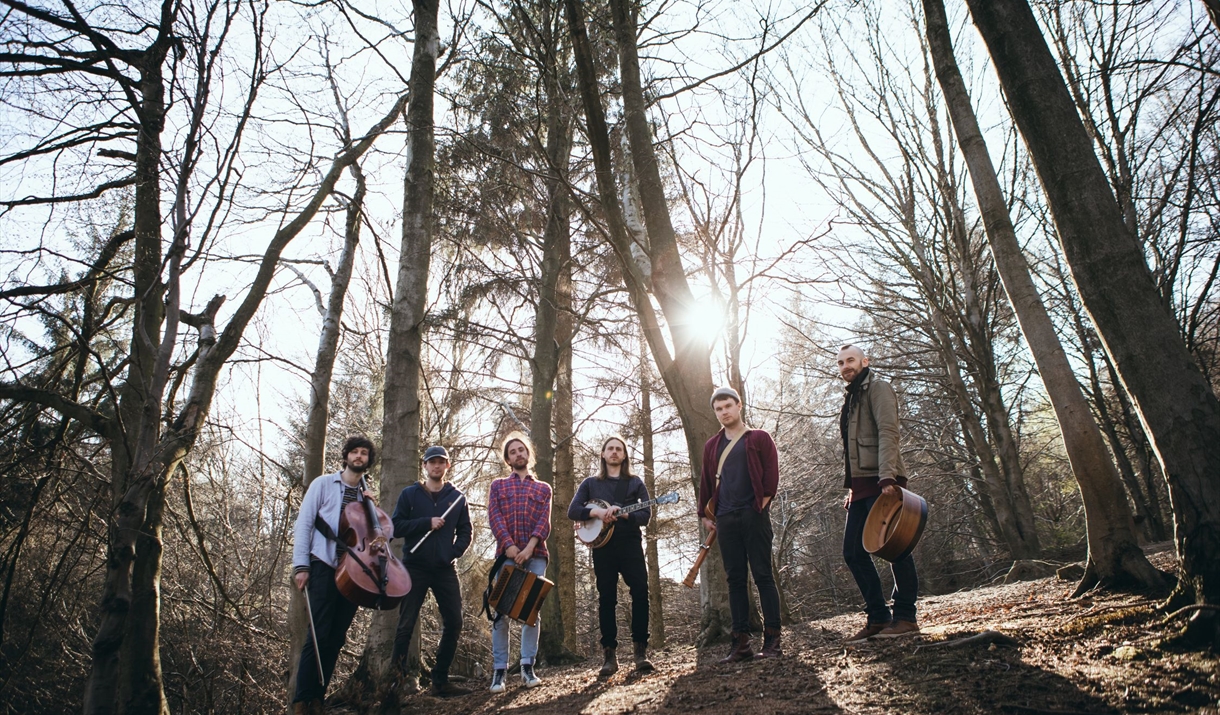 Group of musicians among trees Group of musicians among trees