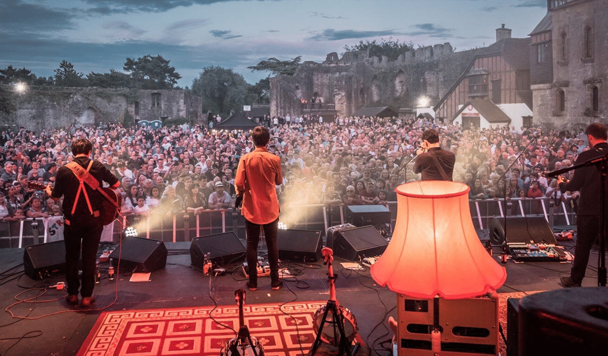 rusty shackle live at caldicot castle crowd and castle in background rusty shackle live at caldicot castle crowd and castle in background