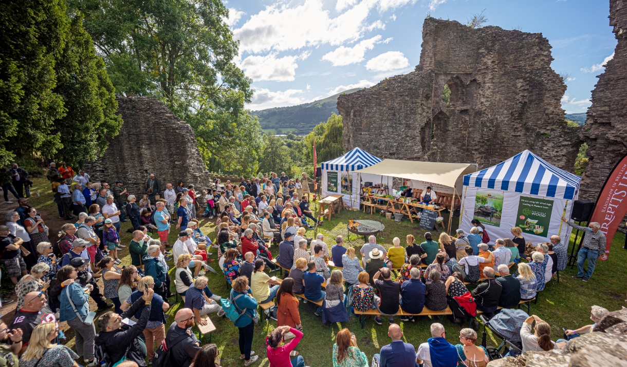 Abergavenny Food Festival in abergavenny castle with crowds watching firepit display on sunny day looks fun Abergavenny Food Festival in abergavenny castle with crowds watching firepit display on sunny day looks fun