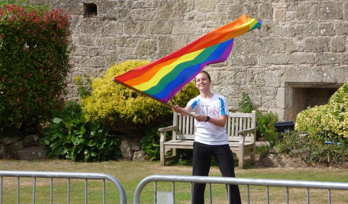 boy waves rainbow flag at cladicot castle boy waves rainbow flag at cladicot castle