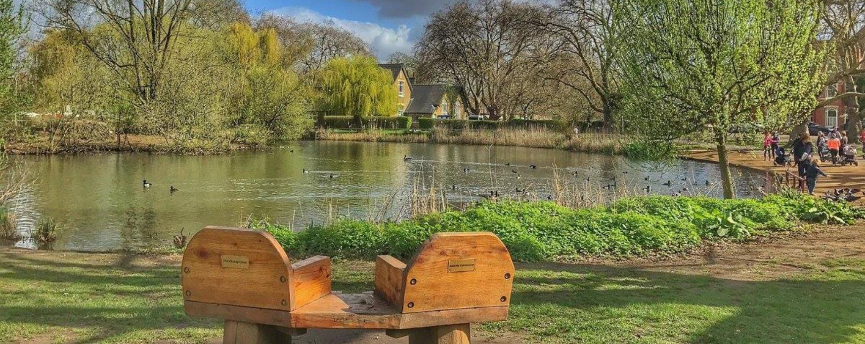 A picture of Barnes pond with people enjoying the sun