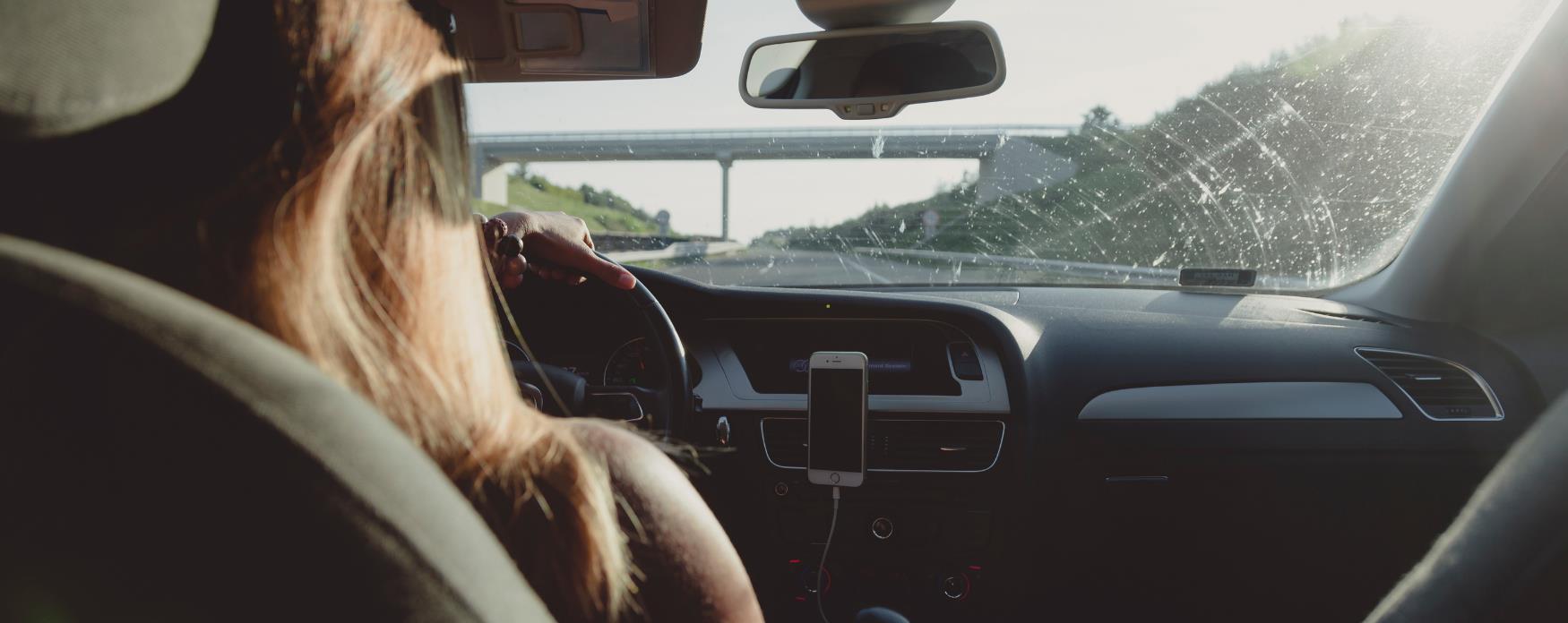 A picture of a lady driving a car to London