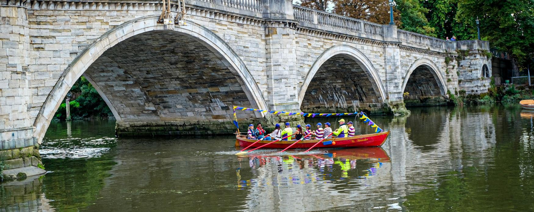 A team of rowers rowing on Richmond Riverside