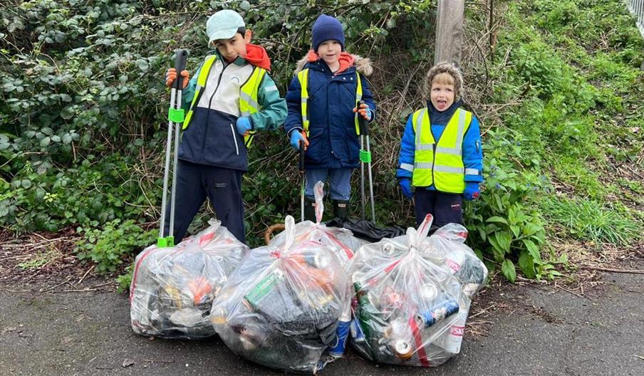 Children with litter pickers and bags of rubbish