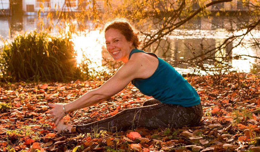 Seated forward bend yoga pose, Hampton riverside