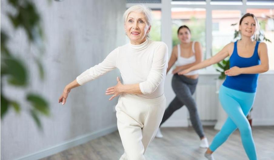 An older woman in a dance class
