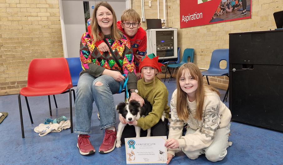 Cute puppy and family at a group training class