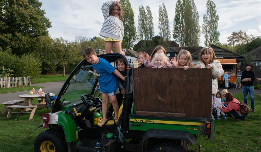 Children on the Gator utility vehicle. Photo by Herman Ng