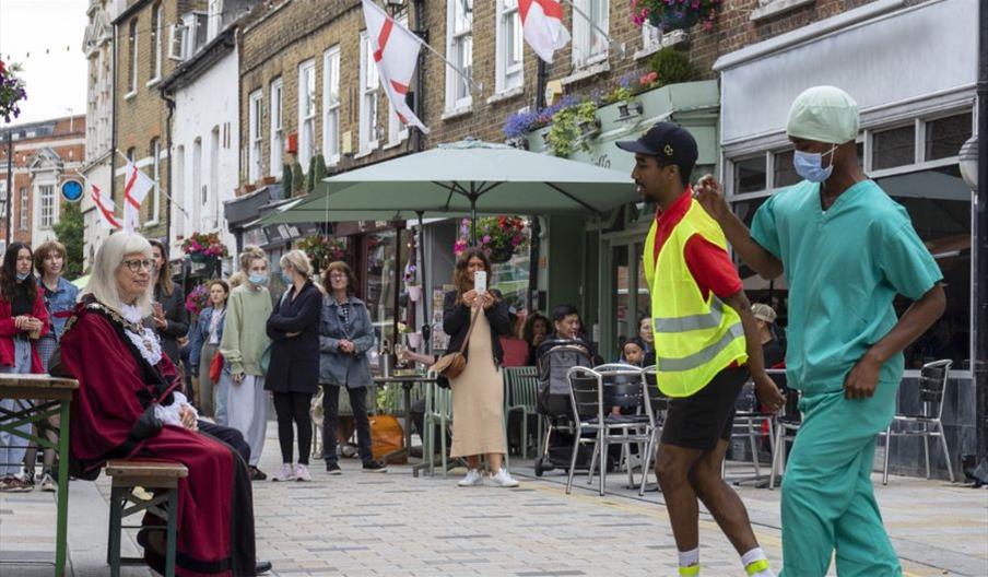 Two dancers dancing on Church Street.