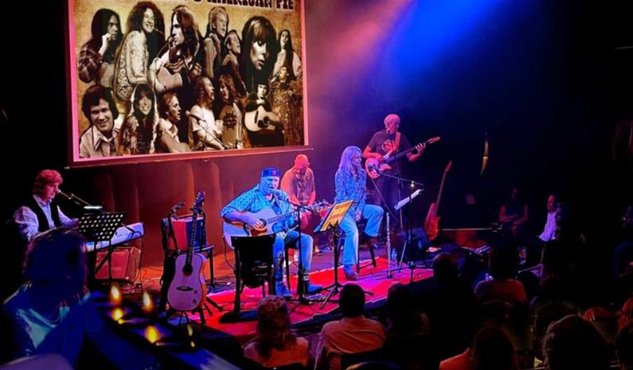 Picture of men and women playing instruments on stage