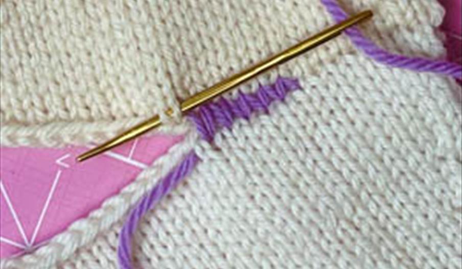 Knitted garment being sewn up