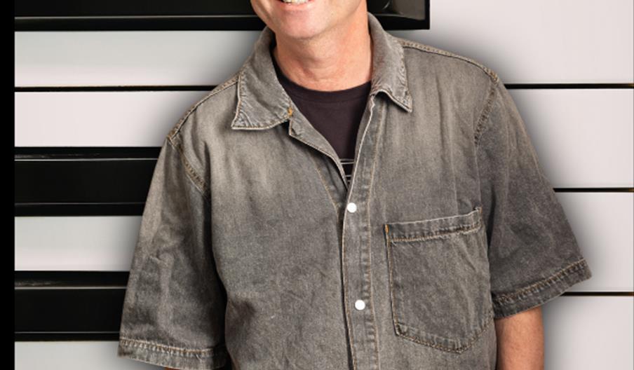 Picture of a man standing in front of piano keys