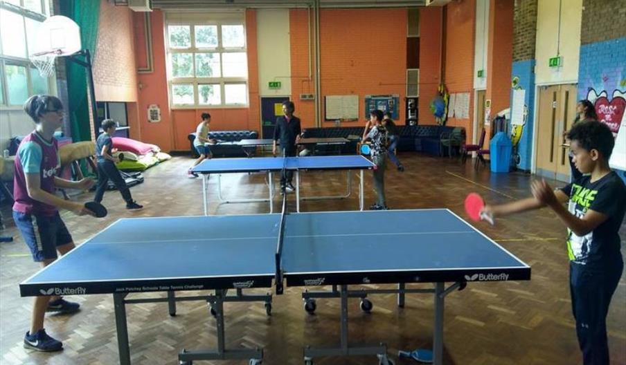 Two kids playing table tennis