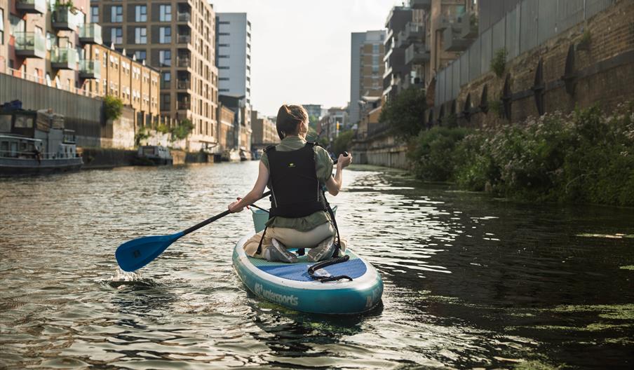 Person on a paddleboard on the river for a litter clean up
