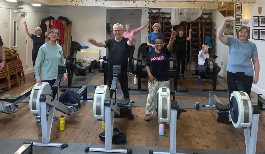 People having fun on rowing machines