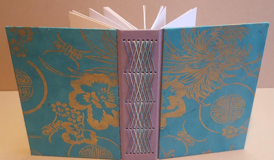 Pink and blue book with stitching