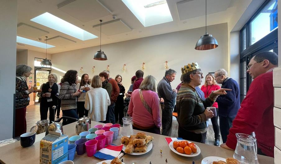 Students practising their French conversation over coffee and croissants