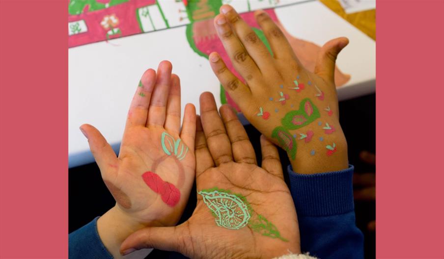 Young people sat around a table doing a creative activity