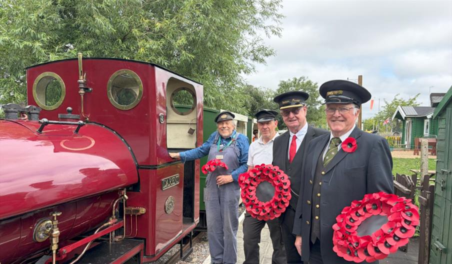 Volunteers from Hampton Kempton Waterworks railway with a poppy-decorated steam train