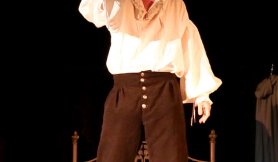 Man standing on a bed and singing