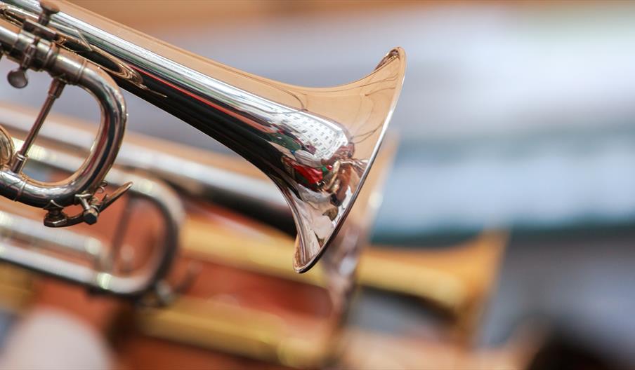 A close-up image of a gold trumpet