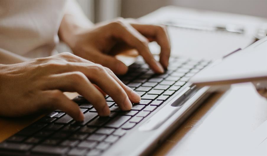 Person typing on keyboard