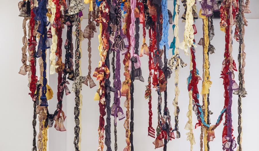 Hanging sculpture of colourful textile garland