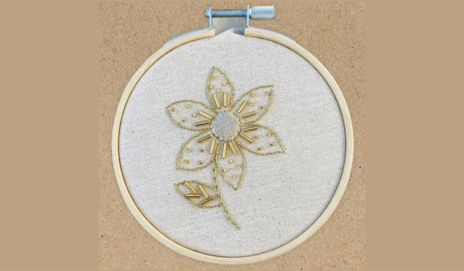 Flower stitched with goldwork