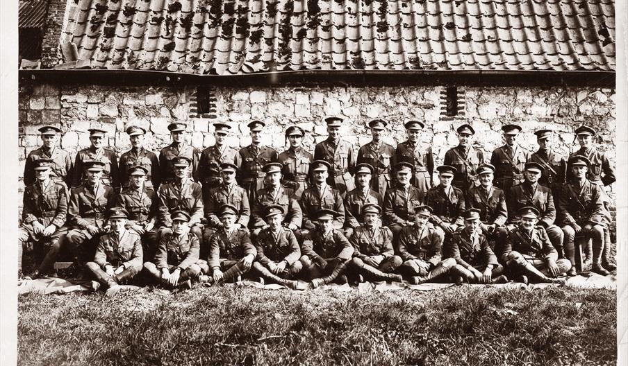 A group of uniformed men posing for a photo.