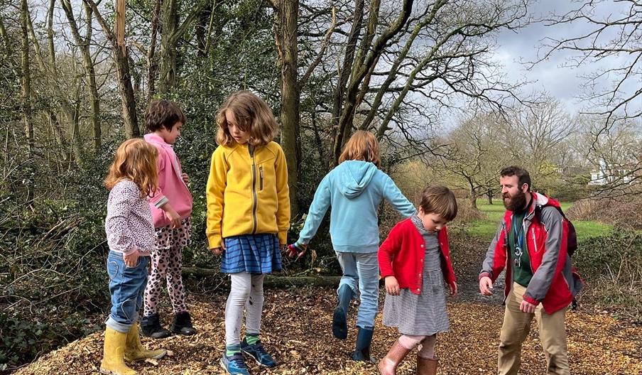 Children on pile of wood chips