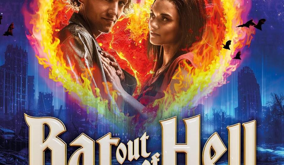 Promotional poster for the musical Bat Out of Hell, featuring a man and woman embracing inside a fiery heart, surrounded by bats against a dark blue