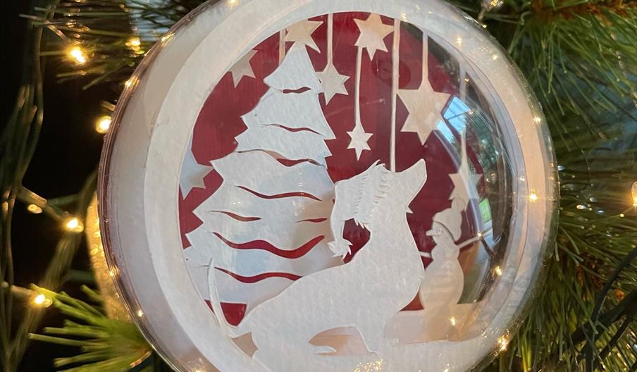 Papercut bauble with dog and stars