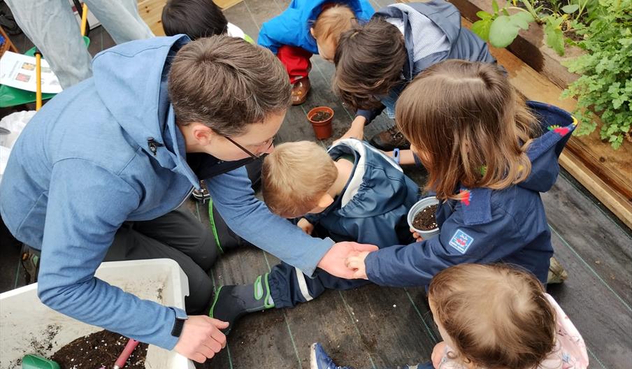 Children and adults at a community growing session