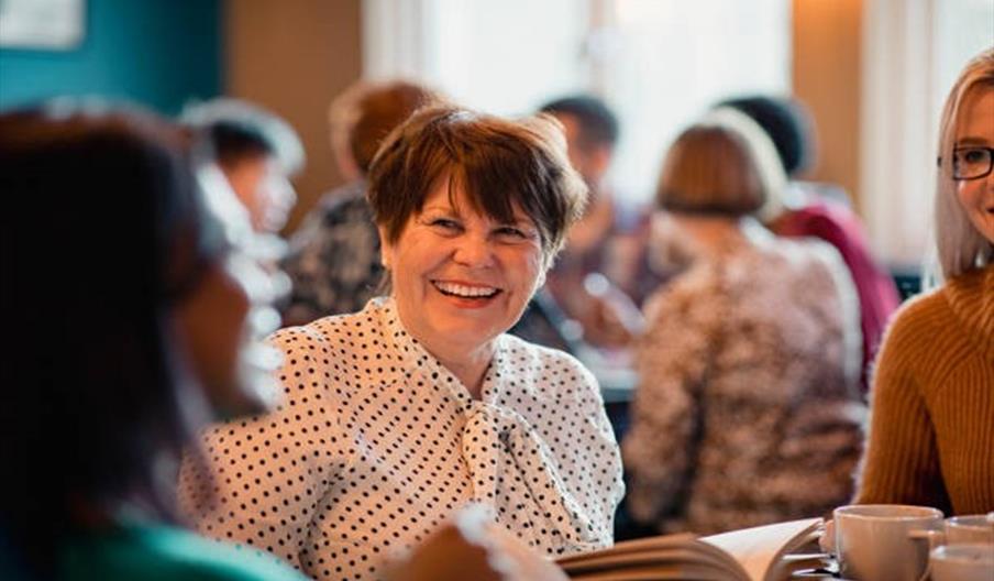 woman at table smiling