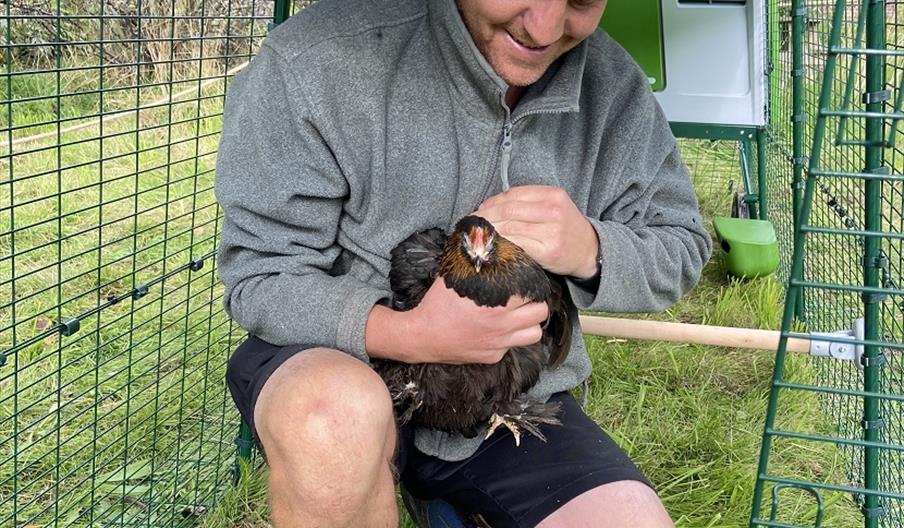 Senior gardener Pete with chicken