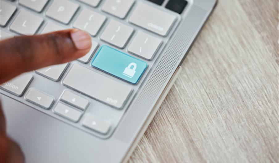 Finger hovering over a keyboard