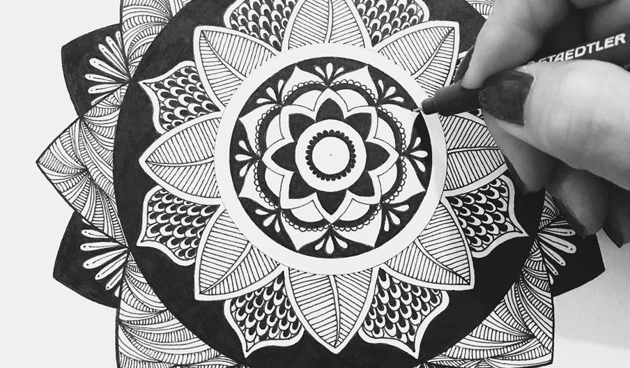 Hand drawing a mandala