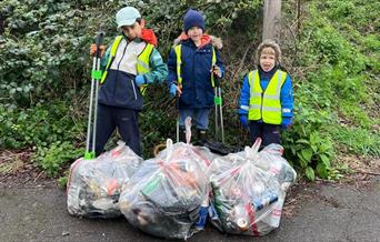 Children with litter pickers and bags of rubbish
