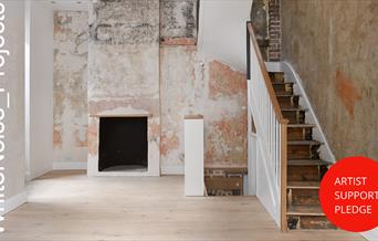 photograph of empty gallery with logos for White Noise Projects and Artist Support Pledge